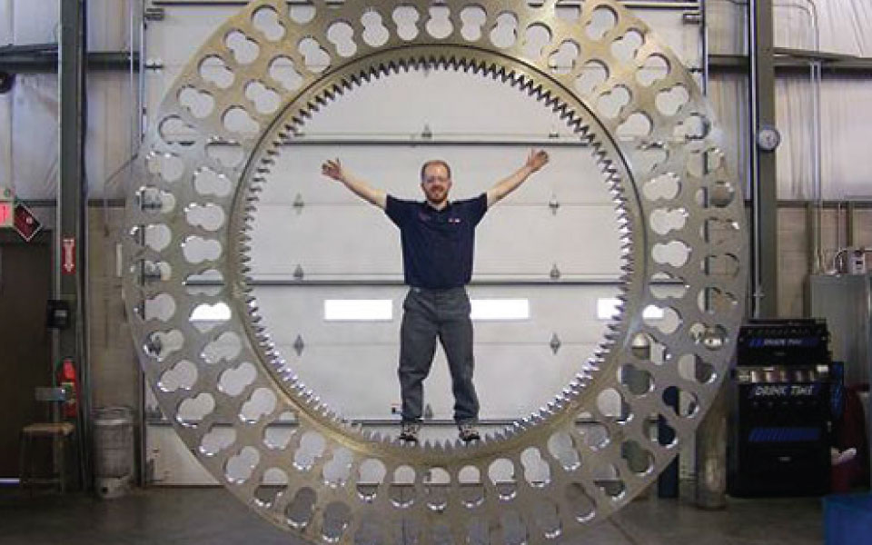 Man standing in a large, circular metal piece.