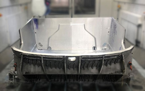 A large. metal box with an open top that is created by precise machining.