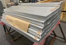 Stacked aluminum posts that have been bent into squares.
